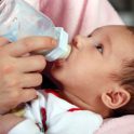 Baby boy drinking milk bottle
